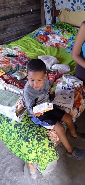 Child receiving food supplies from Cuba Compassion Project