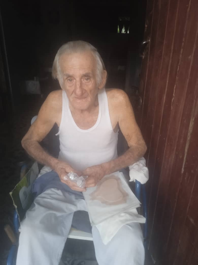 Elderly man receiving medicine and supplies from Cuba Compassion Project