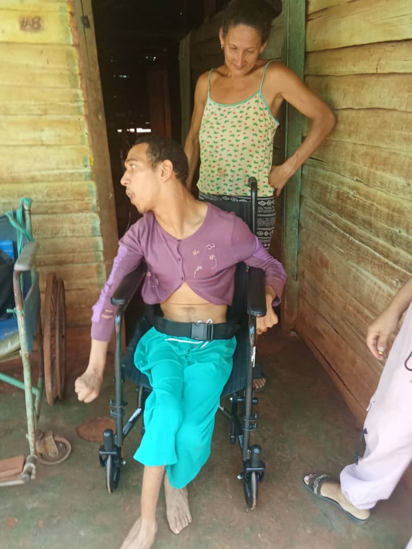 Young man with special needs and his mother receiving a wheelchair from Cuba Compassion Project