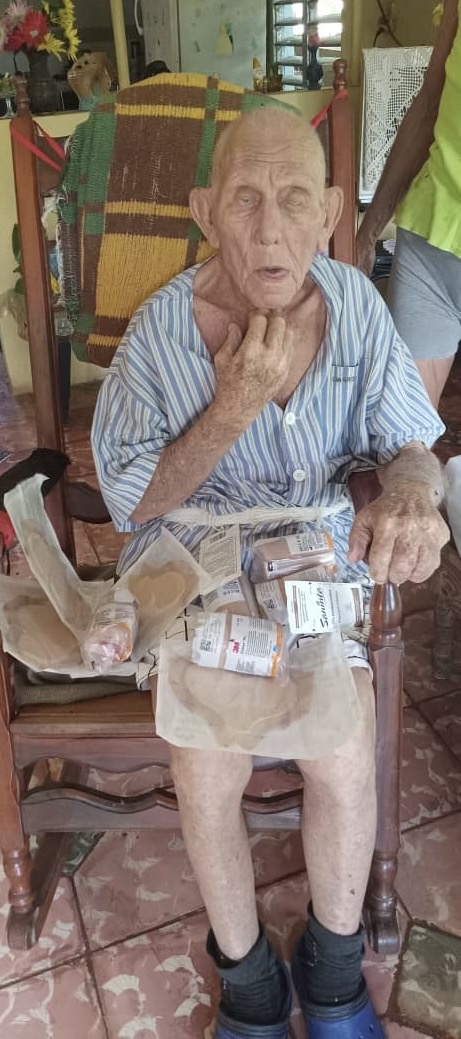 Elderly man receiving medications and supplies at home from Cuba Compassion Project