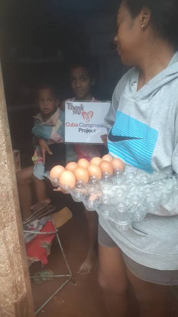 Family receiving eggs and supplies from Cuba Compassion Project