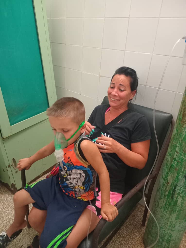 Mother comforting her son during a breathing treatment made possible by Cuba Compassion Project